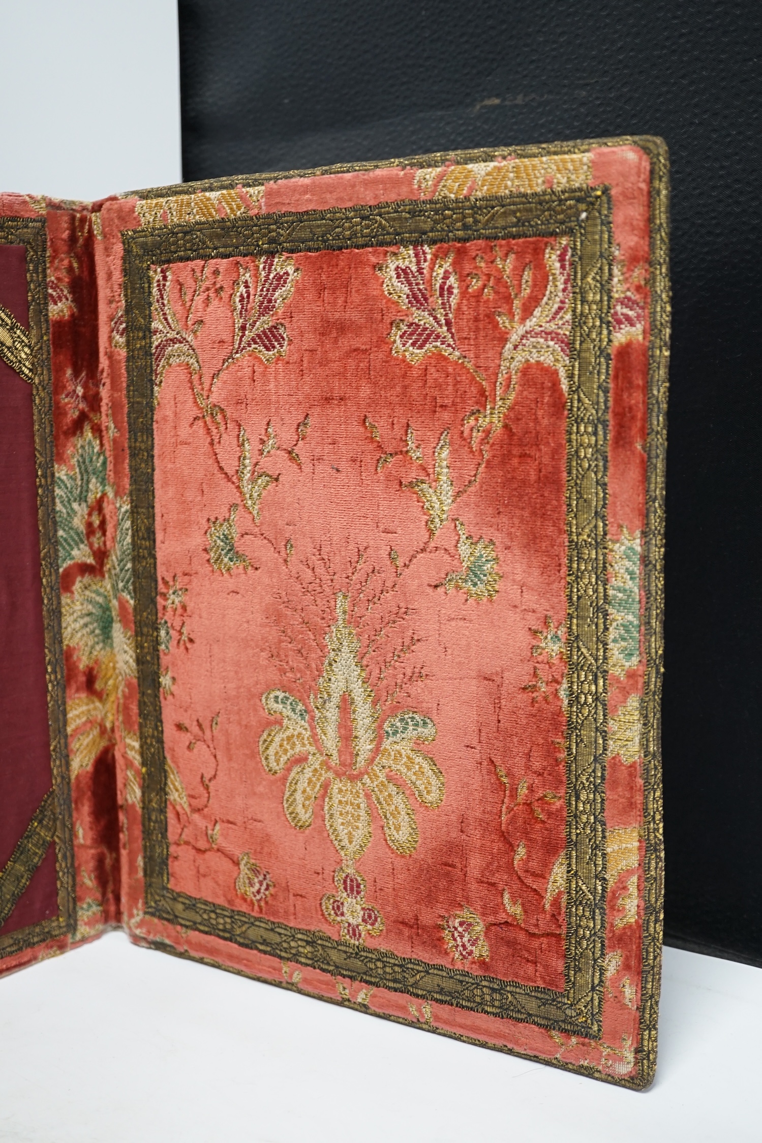 An 18th century style embroidered writing pad in damask and velvet, 32 x 51cm. Condition - poor to fair, generally faded